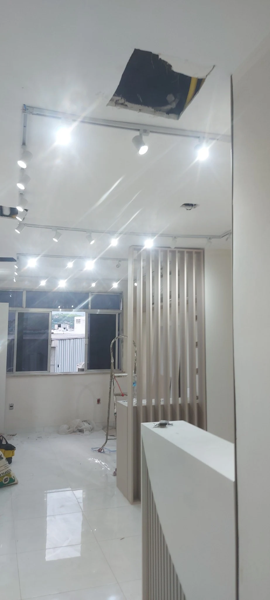 Ambiente comercial com trilhos e spots de iluminação já instalados.